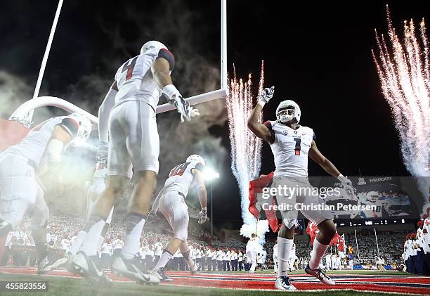 Wide receiver Cayleb Jones of the Arizona Wildcats leads teammates out onto the field before the college football game against the California Golden...