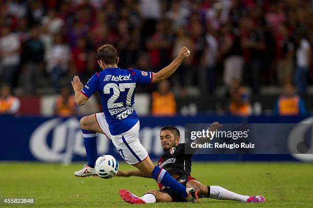 Rodrigo Millar of Atlas fights for the ball with Hernan Bernardello of Cruz Azul during a match between Atlas and Cruz Azul as part of 9th round...