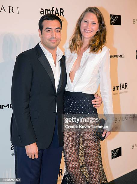 Mohammed Al Turki and Catherine McNeil attend amfAR Milano 2014 event during Milan Fashion Week Womenswear Spring/Summer 2015 on September 20, 2014...