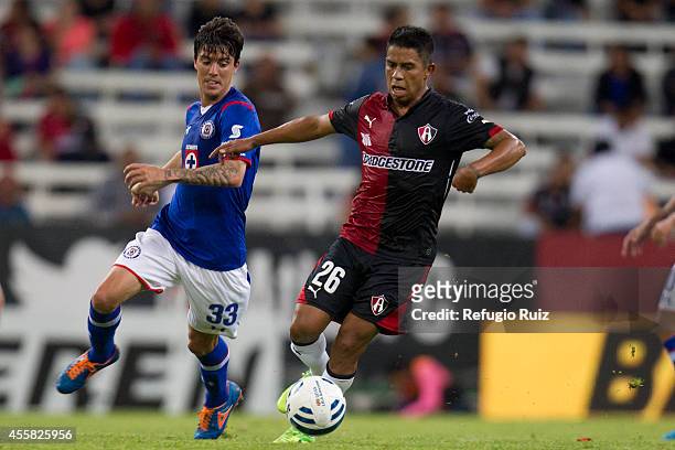 Juan Carlos Medina of Atlas fights for the ball with Mauro Formica of Cruz Azul during a match between Atlas and Cruz Azul as part of 9th round...