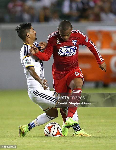 Andres Escobar of FC Dallas collides with A.J. DeLaGarza of of the Los Angeles Galaxy as they fight for the ball at StubHub Center on September 20,...
