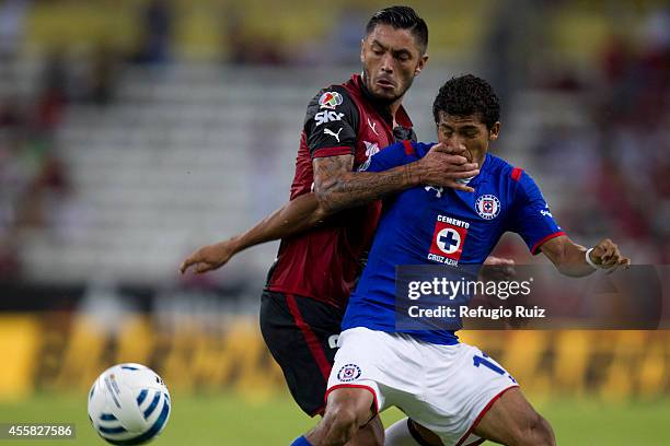Rodrigo Millar of Atlas tries to steal the ball from Joao Rojas of Cruz Azul during a match between Atlas and Cruz Azul as part of 9th round Apertura...