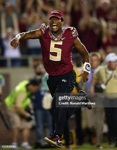 Jameis Winston of the Florida State Seminoles runs on the field to celebrate the overtime win against the Clemson Tigers at Doak Campbell Stadium on...