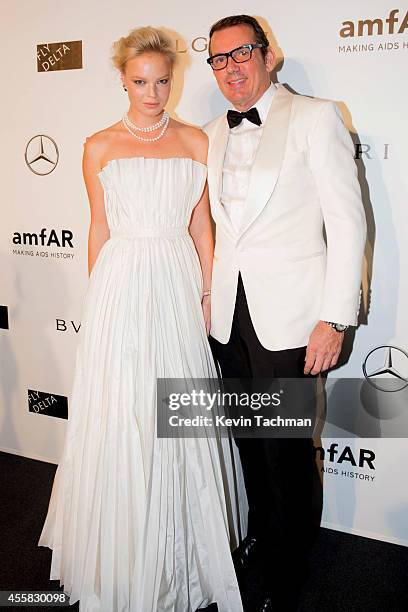 Dasha Zharova and Thomas Leclercq attend the amfAR Milano 2014 cocktail party as part of Milan Fashion Week Womenswear Spring/Summer 2015 on...