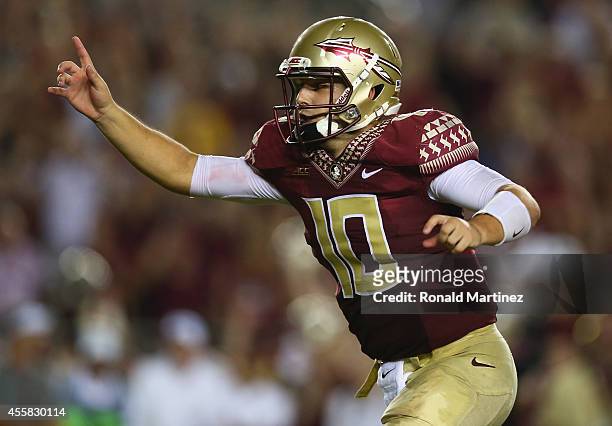 Sean Maguire of the Florida State Seminoles celebrates the overtime win against the Clemson Tigers at Doak Campbell Stadium on September 20, 2014 in...