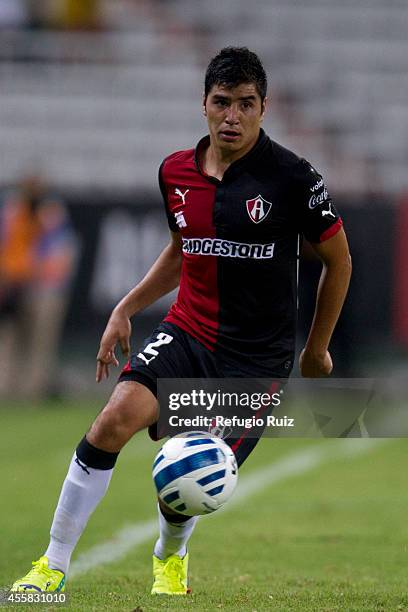 Enrique Perez of Atlas drives the ball during a match between Atlas and Cruz Azul as part of 9th round Apertura 2014 Liga MX at Jalisco Stadium on...