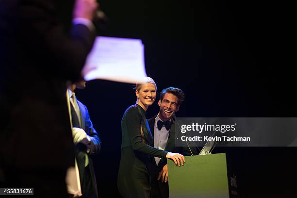 Toni Garrn and Jon Kortajaren appear on stage during the amfAR Milano 2014 - Gala Dinner and Auction as part of Milan Fashion Week Womenswear...