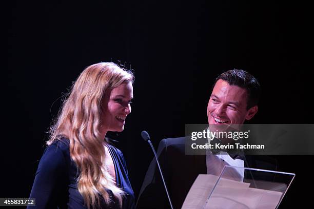 Fiammetta Cicogna and Luke Evans appear on stage during the amfAR Milano 2014 - Gala Dinner and Auction as part of Milan Fashion Week Womenswear...