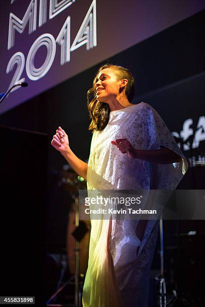 Rosario Dawson appears on stage during the amfAR Milano 2014 - Gala Dinner and Auction as part of Milan Fashion Week Womenswear Spring/Summer 2015 on...