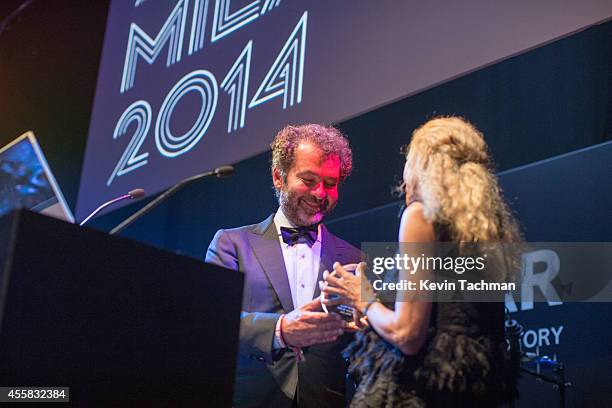 Remo Ruffini and Franca Sozzani appear on stage during the amfAR Milano 2014 - Gala Dinner and Auction as part of Milan Fashion Week Womenswear...