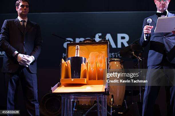 Items are auctioned off during the amfAR Milano 2014 - Gala Dinner and Auction as part of Milan Fashion Week Womenswear Spring/Summer 2015 on...