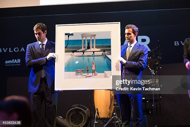 Items are auctioned off during the amfAR Milano 2014 - Gala Dinner and Auction as part of Milan Fashion Week Womenswear Spring/Summer 2015 on...