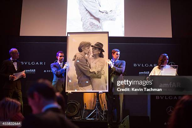 Items are auctioned off during the amfAR Milano 2014 - Gala Dinner and Auction as part of Milan Fashion Week Womenswear Spring/Summer 2015 on...