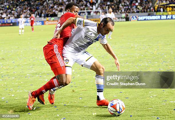 Landon Donovan of the Los Angeles Galaxy is brought down by Kellyn Acosta of FC Dallas at StubHub Center on September 20, 2014 in Los Angeles,...