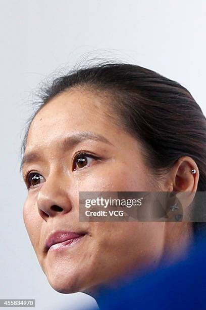 Li Na speaks to the media during a press conference after announcing her retirement at the National Tennis Centre on September 21, 2014 in Beijing,...