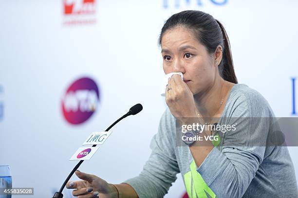 Li Na speaks to the media during a press conference after announcing her retirement at the National Tennis Centre on September 21, 2014 in Beijing,...