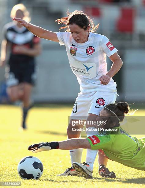 Michelle Carney of the Wanderers beats goal keeper Brianna Davey of the Victory to go on and score a goal during the round two W-League match between...