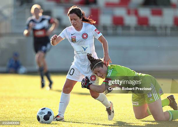 Michelle Carney of the Wanderers beats goal keeper Brianna Davey of the Victory to go on and score a goal during the round two W-League match between...