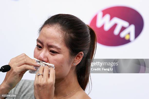 Chinese tennis player Li Na cries during her retirement press conference at the National Tennis Centre on September 21, 2014 in Beijing, China. The...