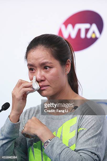 Chinese tennis player Li Na cries during her retirement press conference at the National Tennis Centre on September 21, 2014 in Beijing, China. The...