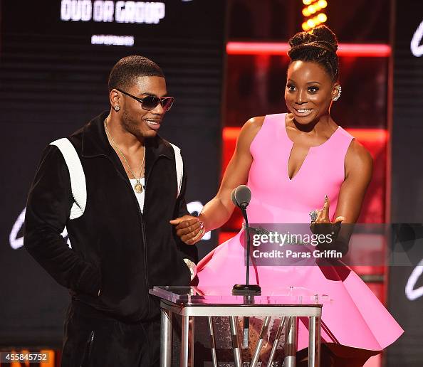 Rapper Nelly and actress Erica Ash speak onstage during the BET Hip ...
