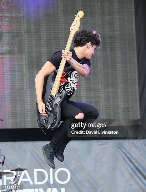 Musician Calum Hood of 5 Seconds of Summer performs on stage at the 2014 iHeartRadio Music Festival Village on September 20, 2014 in Las Vegas,...