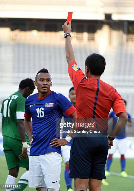 Mohd Zubir of Malaysia is shown the red card by the referee during the Football Mens Group A match between Malaysia and Saudi Arabia during day two...