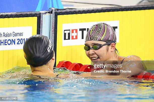 Zhang Yuhan of China celebrates with Bi Yirong of China after winning gold in the Women's 400m Freestyle during day two of the 2014 Asian Games at...