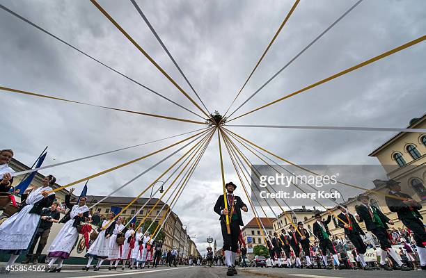 Local bavarian costume groups take part at the traditional costume parade on day two of the 2014 Oktoberfest on September 21, 2014 in Munich,...