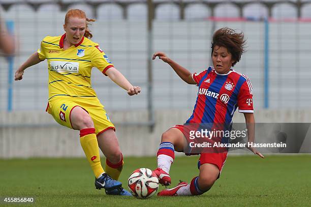 Mana Iwabuchi of Muenchen battles for the ball with Lena Weiss of Hoffenheim during the Allianz Frauen-Bundesliga match between FC Bayern Muenchen...