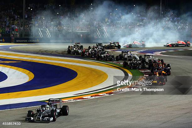 Lewis Hamilton of Great Britain and Mercedes GP leads the field out of turn two as drivers lock up during the Singapore Formula One Grand Prix at...
