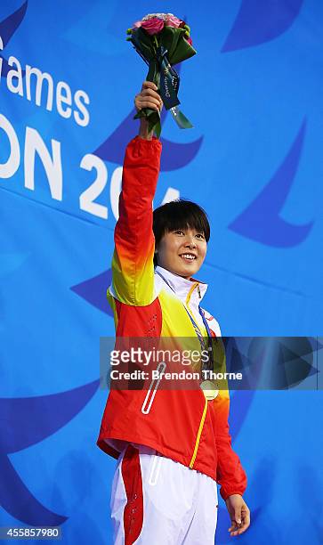 Gold medalist, Zhang Yuhan of China celebrates atop the podium after the Women's 400m Freestyle Final during day two of the 2014 Asian Games at...