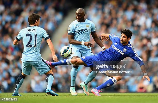 David Silva and Eliaquim Mangala of Manchester City compete with Diego Costa of Chelsea during the Barclays Premier League match between Manchester...