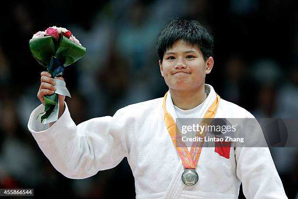 Silver medalist Junxia Yang of China celebrate during the medal ceremony after the Women's -63 kg Final against Dawoon Joung of South Korea at Dowon...