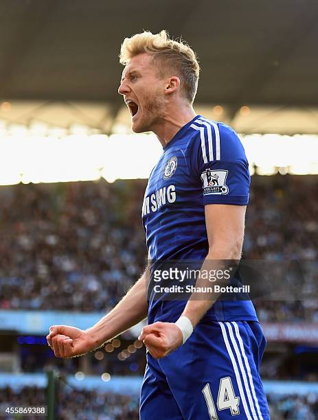 Andre Schurrle of Chelsea celebrates scoring the first goal with his team-mates during the Barclays Premier League match between Manchester City and...