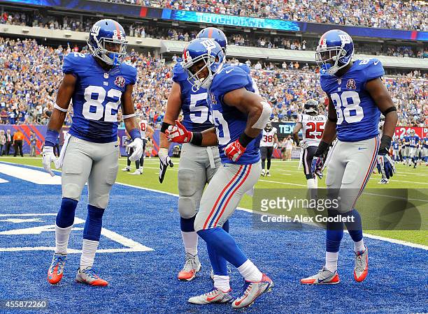 Victor Cruz of the New York Giants celebrates his touchdown with a dance against the Houston Texans in the second quarter at MetLife Stadium on...
