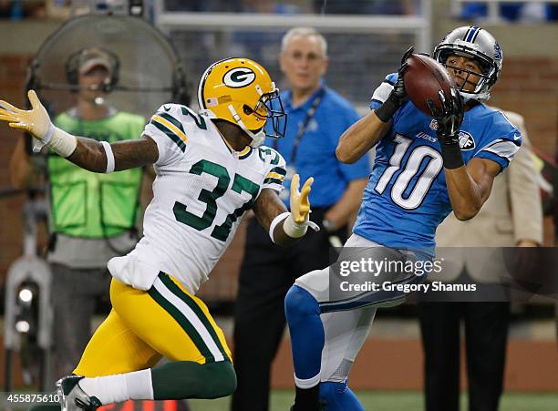 Corey Fuller of the Detroit Lions catches a second quarter interception behind Sam Shields of the Green Bay Packers at Ford Field on September 21,...