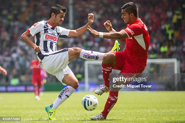 Miguel Ponce of Toluca fights for the ball with Severo Meza of Monterrey during a match between Toluca and Monterrey as part of 9th round Apertura...