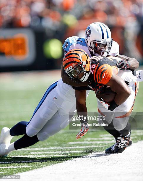 Giovani Bernard of the Cincinnati Bengals is knocked out of bounds by Bernard Pollard of the Tennessee Titans during the third quarter at Paul Brown...