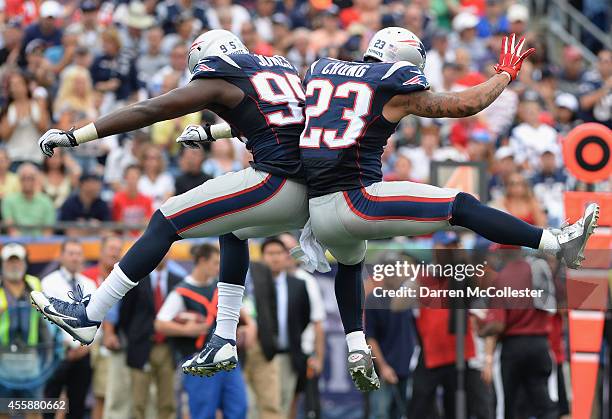 Chandler Jones and Patrick Chung of the New England Patriots celebrate during the fourth quarter against the Oakland Raiders at Gillette Stadium on...