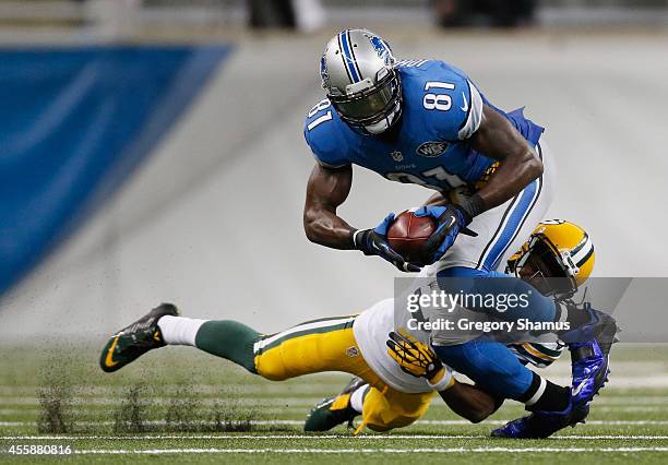 Calvin Johnson of the Detroit Lions tries to avoid the tackle by Tramon Williams of the Green Bay Packers in the fourth quarter at Ford Field on...