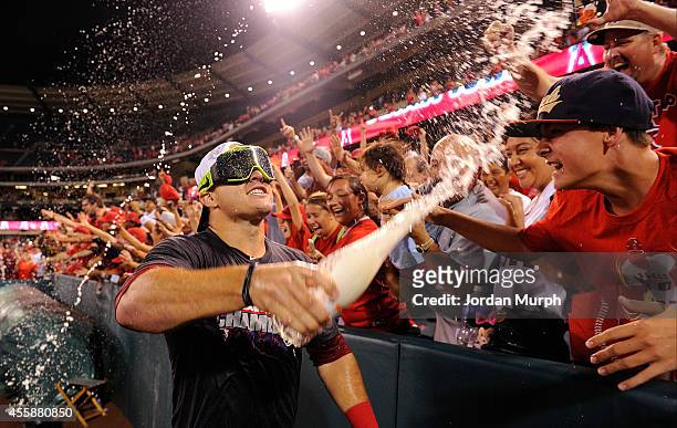 Mike Trout of the Los Angeles Angels of Anaheim celebrates with fans after clinching the American League West Division after the game against the...