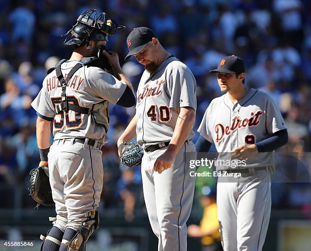 PItcher Phil Coke of the Detroit Tigers stands on the mound with Bryan Holaday as he waits be taken out of a game against the Kansas City Royals in...