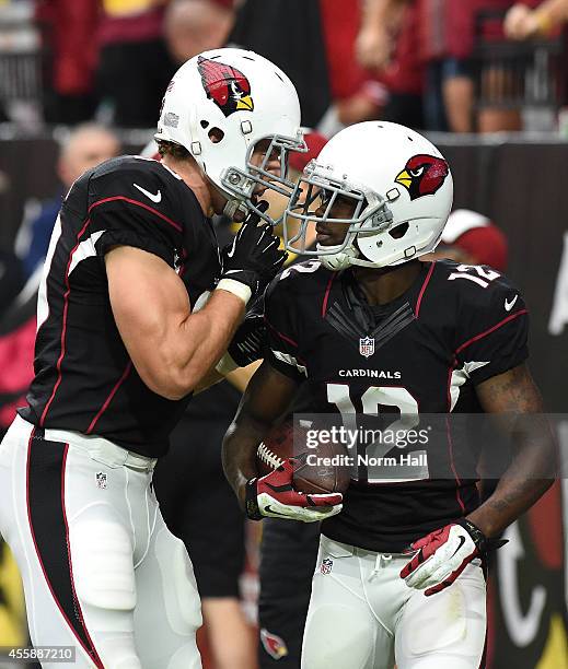 Wide receiver John Brown of the Arizona Cardinals celebrates his second third-quarter touchdown with tight end John Carlson during an NFL game...