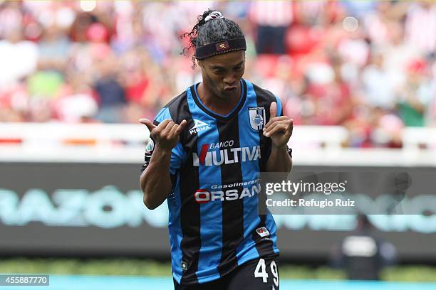 Ronaldinho of Queretaro celebrates after scoring the opening goal from the penalty spot during a match between Chivas and Queretaro as part of 9th...