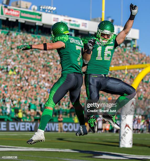 Weston Dressler and Brett Swain of the Saskatchewan Roughriders celebrate the two point conversion that tied the game between the Ottawa Redblacks...