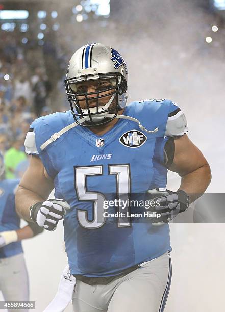 Dominic Raiola of the Detroit Lions runs onto the field during player introductions prior to the start of the game against the Green Bay Packers at...