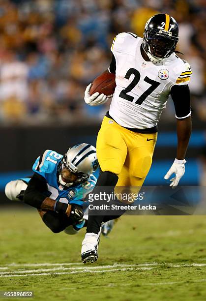 LeGarrette Blount of the Pittsburgh Steelers runs away from Thomas DeCoud of the Carolina Panthers in the second half during the game at Bank of...