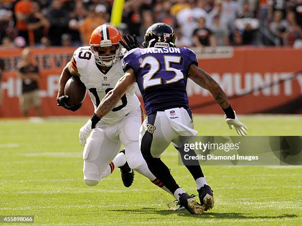 Wide receiver Miles Austin of the Cleveland Browns stiff arms cornerback Asa Jackson of the Baltimore Ravens during a game on September 21, 2014 at...
