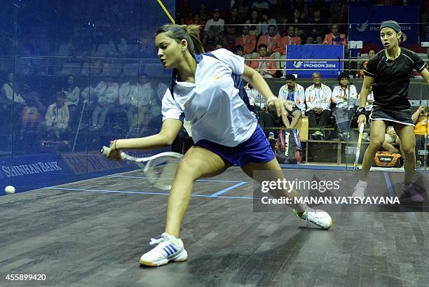 India's Dipika Pallikal returns a shot against Malaysia's Nicol Ann David during the women's squash semi-final match of the 2014 Asian Games at the...